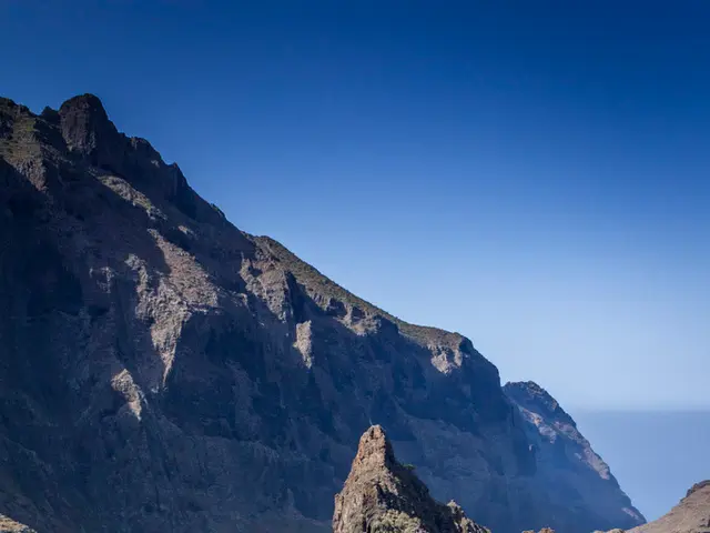 This picture is clicked outside the city. In the center we can see the houses, trees and the rocks....