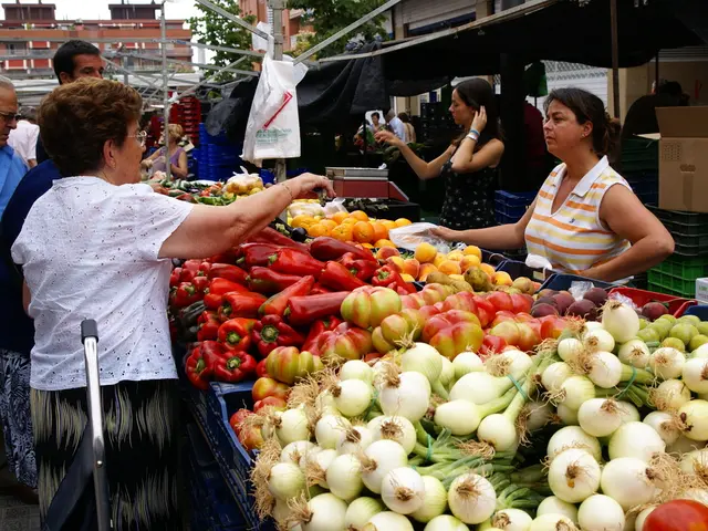 In this image there are vegetables in plastic containers, group of people standing, buildings,...